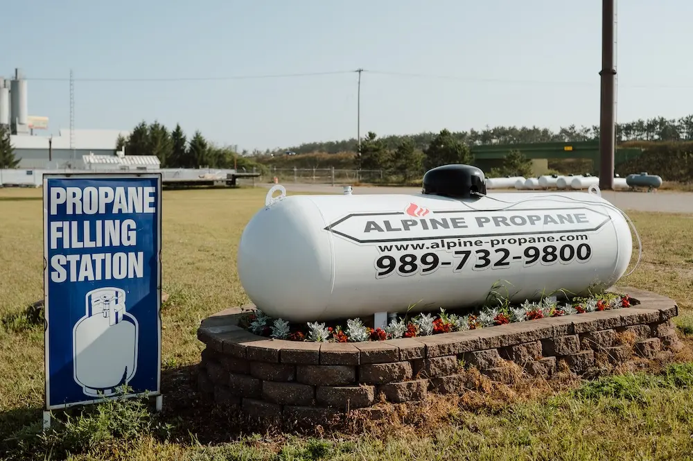 A propane tank monitor from Alpine Propane sitting atop one of their propane tanks.