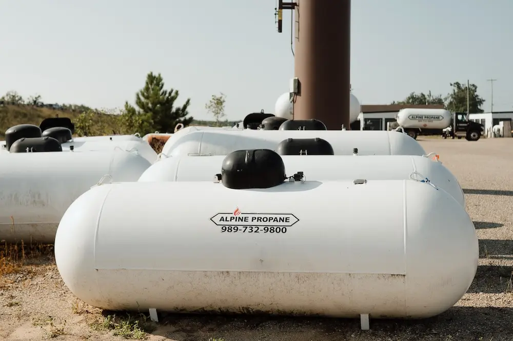 A propane tank monitor from Alpine Propane sitting atop one of their propane tanks.